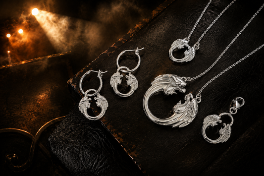 Jesus Christ Superstar sterling silver jewellery collection featuring necklaces, hoop earrings and clip-on charms in a dramatic theatre-inspired flat lay.