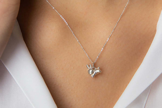Model wearing a sterling silver Miffy rabbit pendant necklace from Licensed To Charm, handmade and inspired by characters we love.