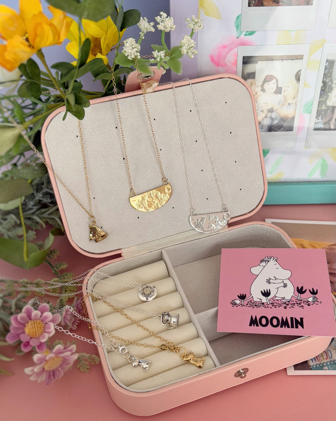 "Handcrafted Moomins jewellery displayed in an open jewellery box, featuring a delicate Moomintroll charm necklace and a silver Snorkmaiden charm