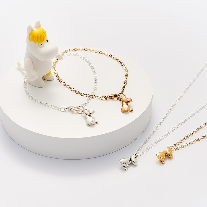 Sterling silver and gold vermeil Moomin necklaces and bracelets displayed on a white stand with a Snorkmaiden figurine – handmade character jewellery by Licensed To Charm