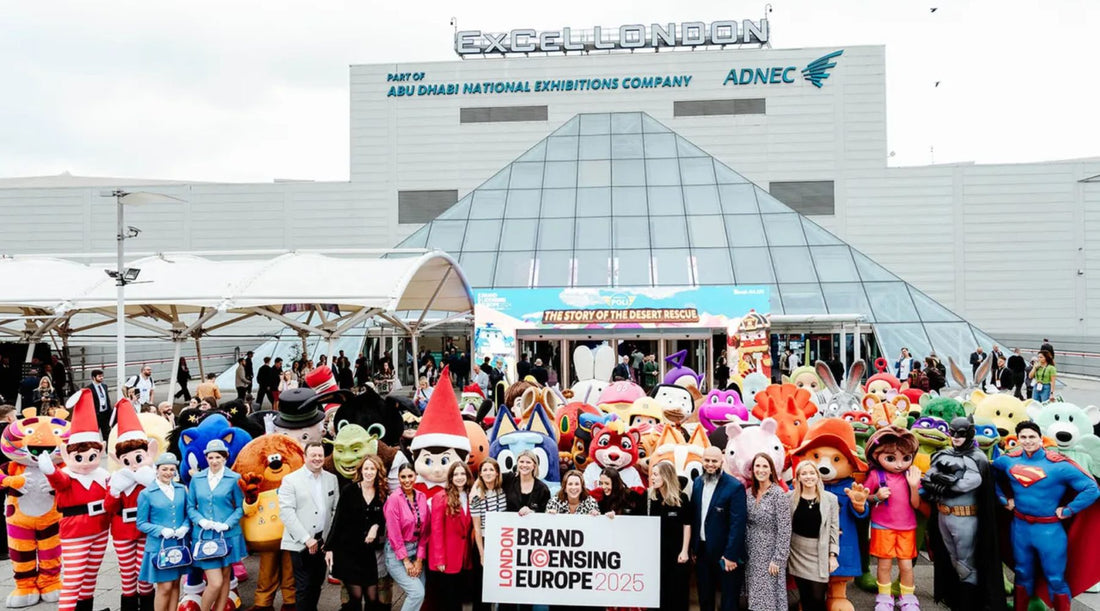 The entrance of ExCeL London for Brand Licensing Europe 2025, with a large group of colourful costumed characters and attendees gathered for the annual licensing event.