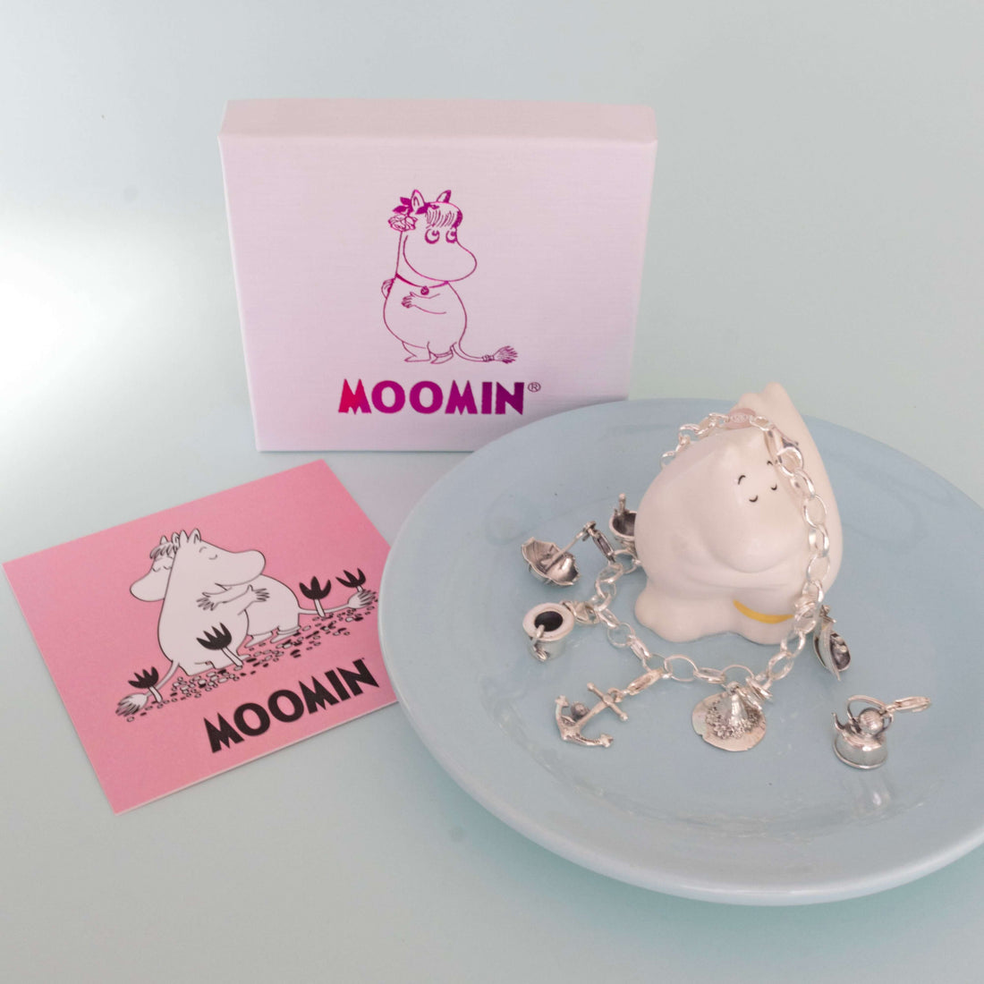 Moomin charm jewellery displayed in a dish with bracelets and collectable sterling silver charms – inspired by the magical world of Moominvalley.