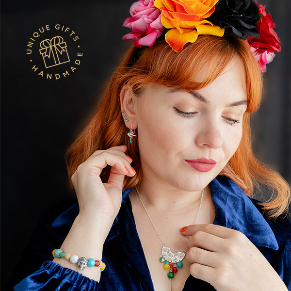 Model wearing the full Frida Kahlo Fiesta jewellery collection, including beaded skull necklace, Creole necklace, and gemstone drop earrings, showcasing colourful handmade designs inspired by Frida’s bold style and crafted in the UK.