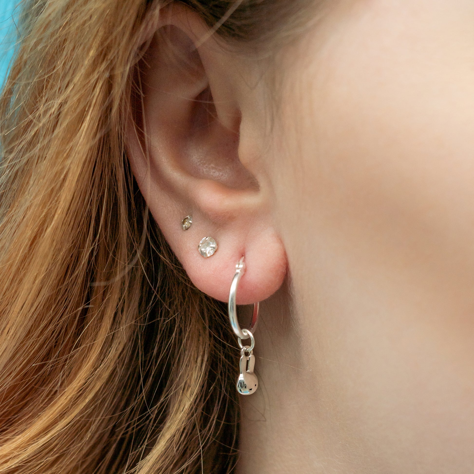 Handcrafted sterling silver Miffy Mini Head Hoop Earrings with seamless hoop design and charming Miffy face. Perfect for everyday wear or gifting.