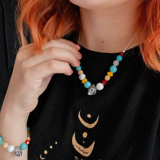 Handcrafted sterling silver Frida Kahlo Sugar Skull Necklace with jade, carnelian, turquoise, and wood beads. Features an oxidized finish and fiery red cord option