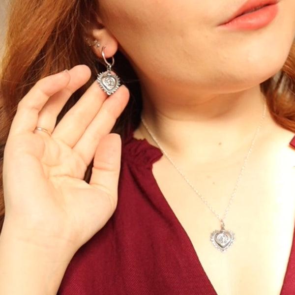 Handcrafted drop earrings featuring a heart-shaped design with Frida Kahlo’s portrait.