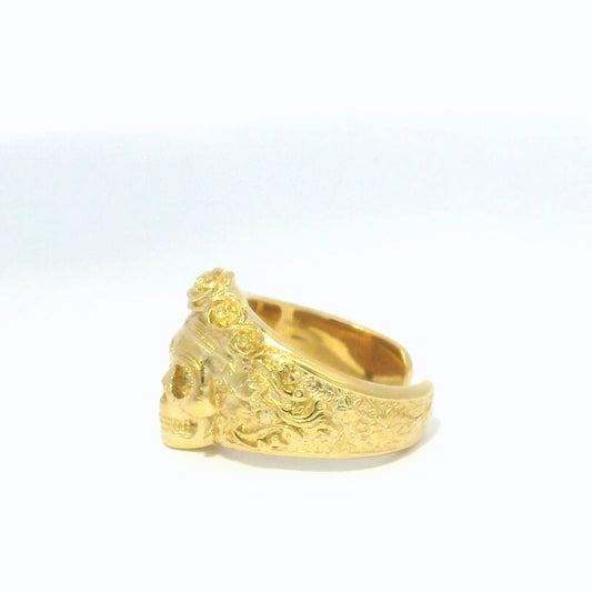 Side view of gold sugar skull ring with carved floral details and rose crown