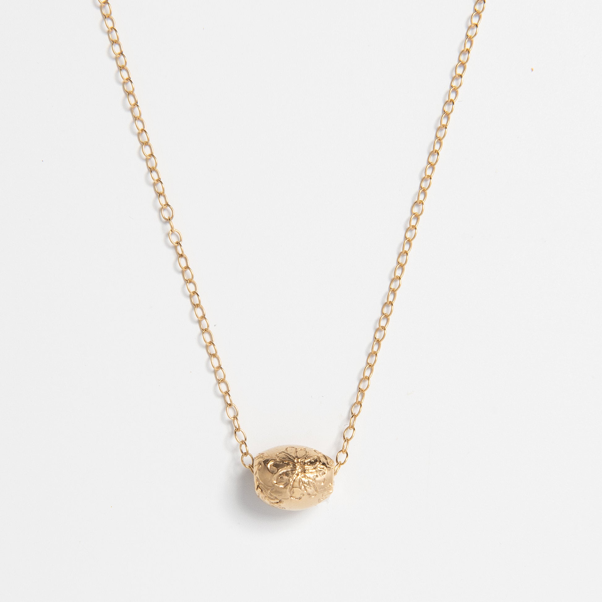 Frida Kahlo Marigold Bead Necklace in sterling silver and 18ct gold vermeil, featuring an engraved marigold design inspired by Casa Azul.