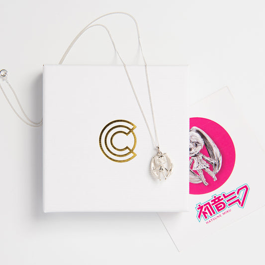 Front-facing view of the Hatsune Miku Sterling Silver Necklace showing the detailed charm with twintails and skirt in polished finish.