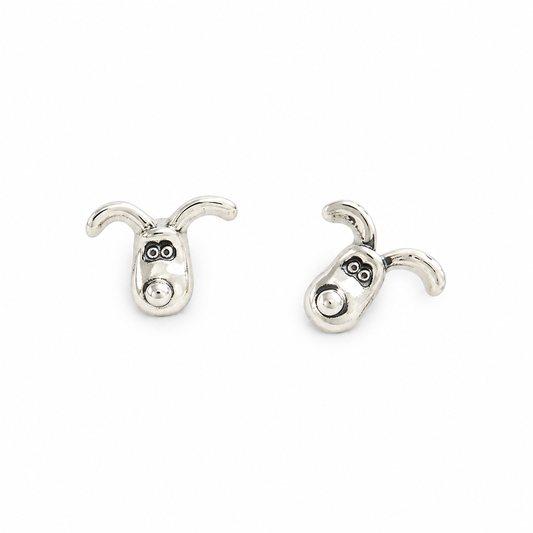 Pair of sterling silver Gromit stud earrings with curved ears and detailed faces, shown on a white background.