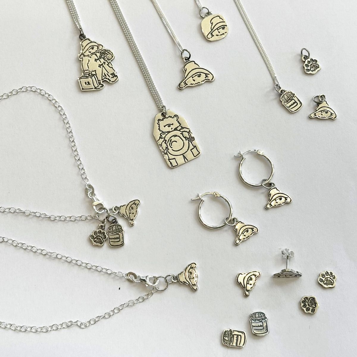 Paddington Bear Jewellery Collection of sterling silver necklaces, bracelets and earrings featuring paddington bear on a white background