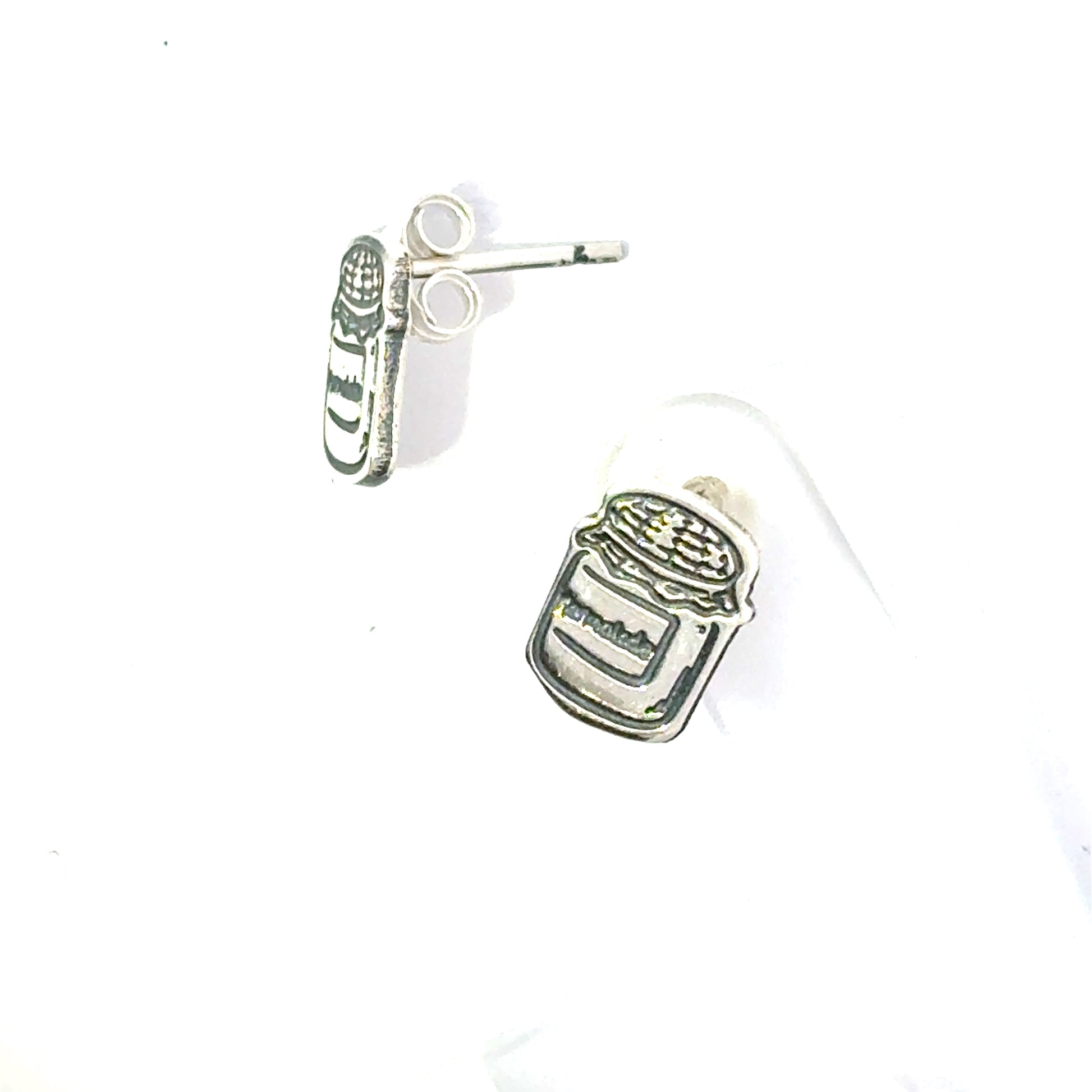 Side profile of Paddington Bear marmalade jar earrings showing engraved detail and jar shape