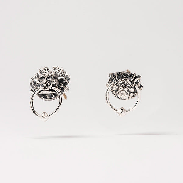 Licensed to charm labyrinth_door_knocker_earrings_close_up on white background
