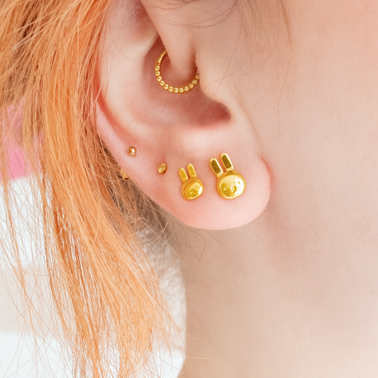 Close-up of Miffy stud earring worn on ear – gold vermeil finish