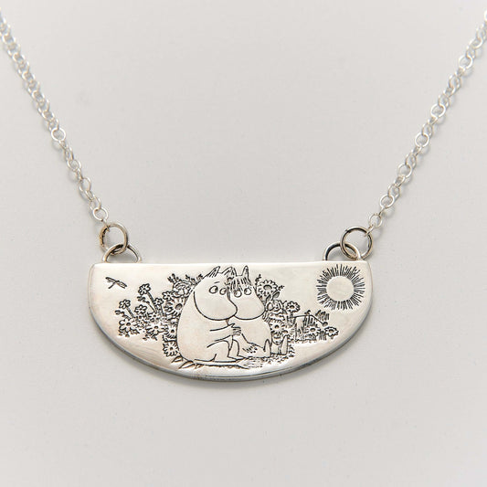Moomin Friends Among Flowers Necklace in sterling silver, featuring a hand-engraved pendant of Moomintroll and Snorkmaiden in a meadow.