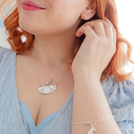 Sterling silver Moomin earrings with mismatched Snorkmaiden and Moomintroll studs. A playful and sustainable accessory for Moomin fans