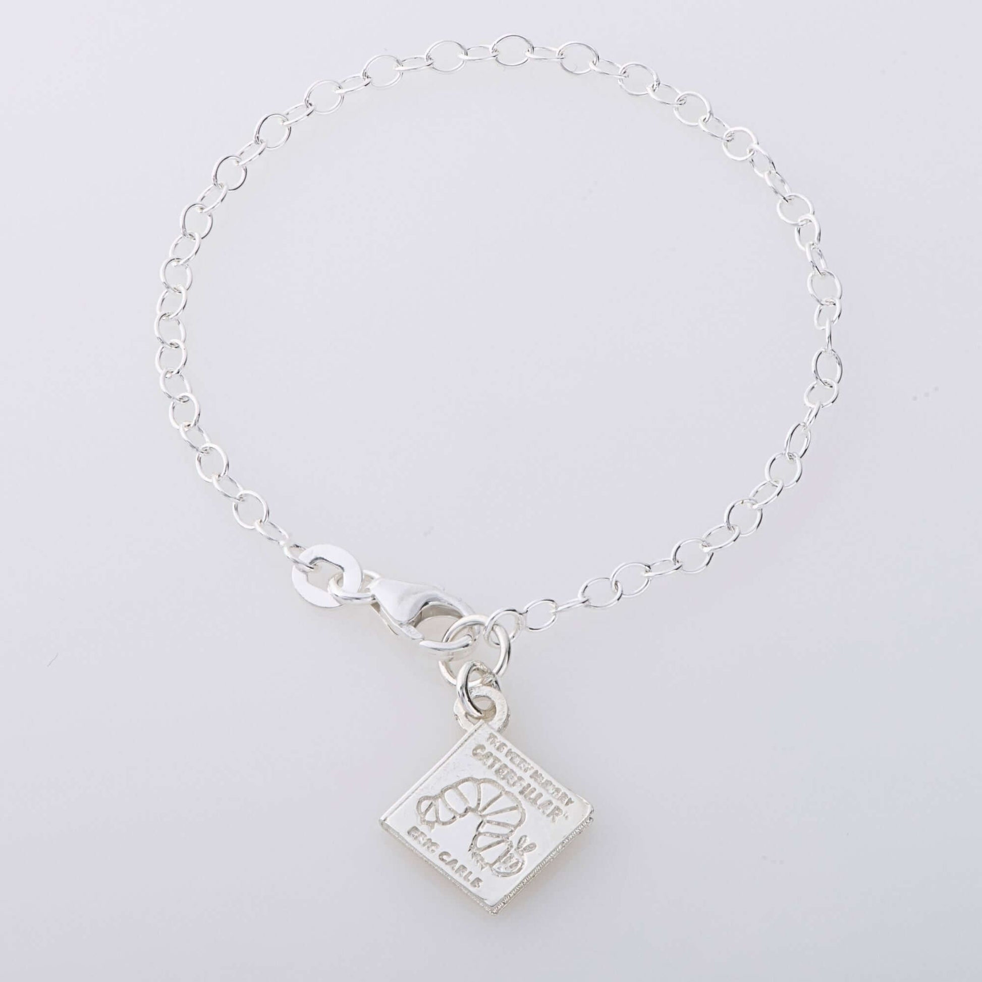 Sterling silver book charm bracelet featuring The Very Hungry Caterpillar engraving. A handmade jewellery gift for book lovers, teachers, and children.