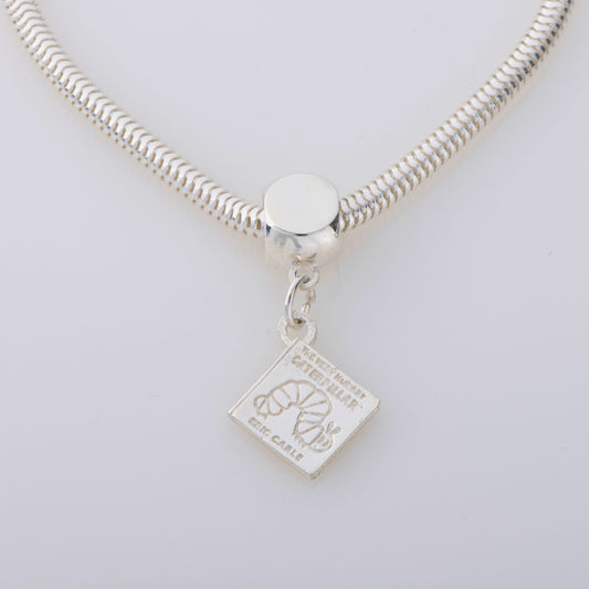 Sterling silver bracelet with a dangling book charm, engraved with The Very Hungry Caterpillar by Eric Carle, on a fine chain.
