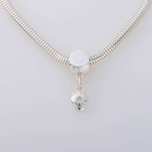 Sterling silver bracelet with a dangling strawberry charm, inspired by The Very Hungry Caterpillar, on a 19cm snake chain.