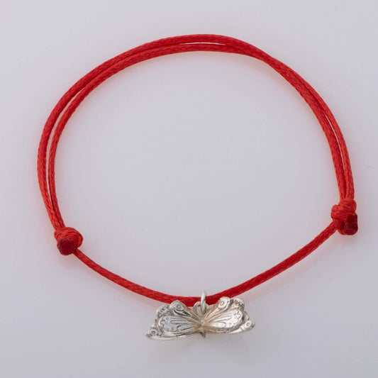 Sterling silver butterfly charm bracelet on a vibrant red adjustable cord, inspired by The Very Hungry Caterpillar. A perfect gift for children and book lovers.
