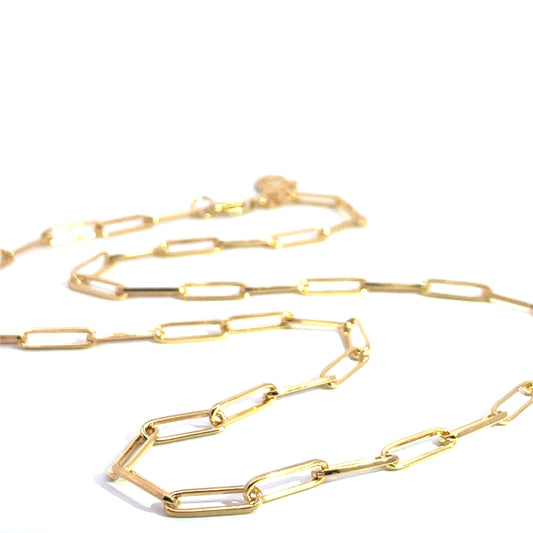 Flatlay of the Paperclip Necklace in 18ct gold vermeil, styled on a neutral background to highlight the elegant charm-ready chain.