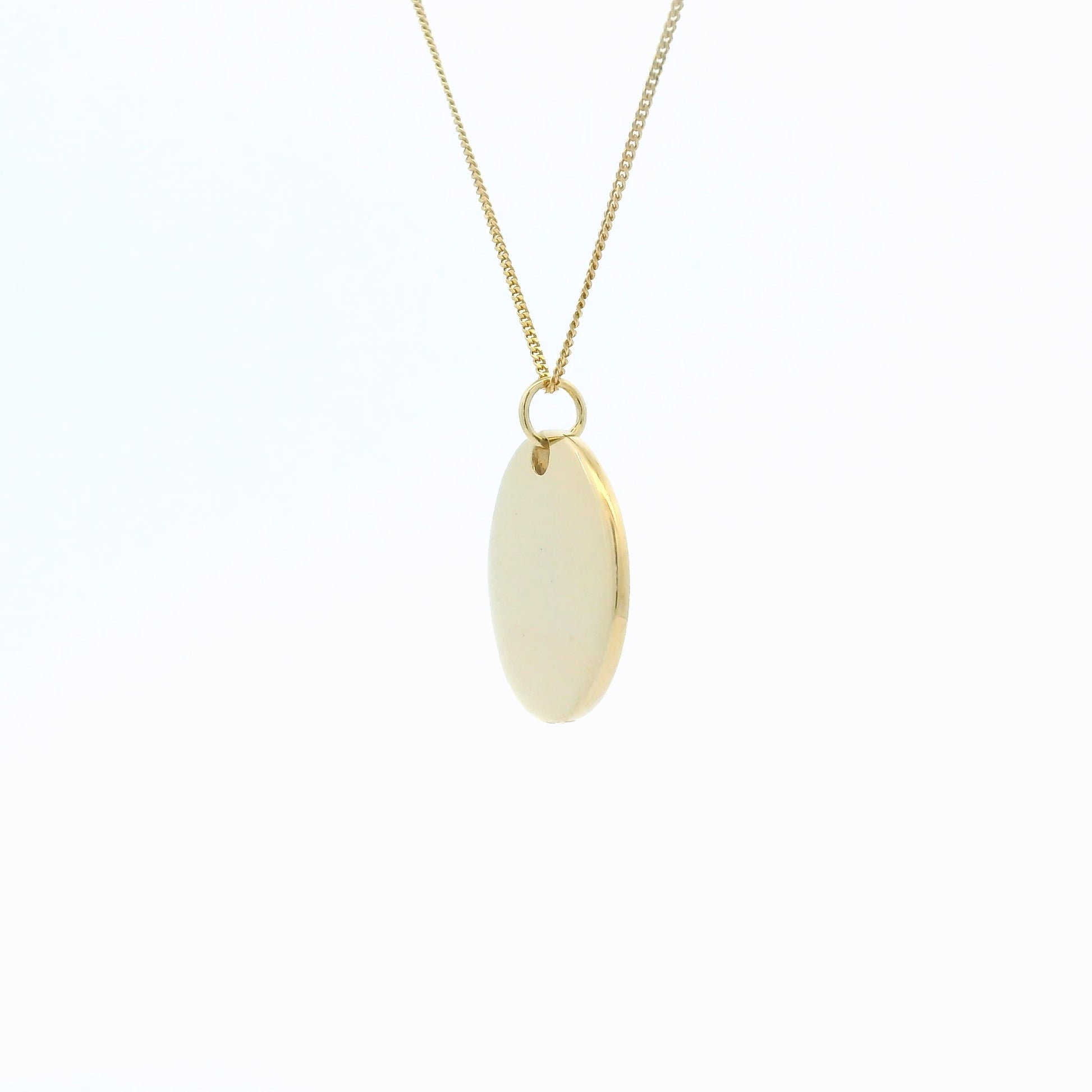 Side angle of Miffy Disc Necklace showing the thickness of the pendant and how it hangs from the gold vermeil chain.