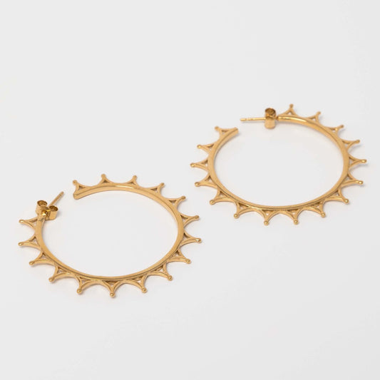 Close-up of the gold vermeil Crown Hoop Earrings, highlighting the detailed crown pattern and polished hoop finish.