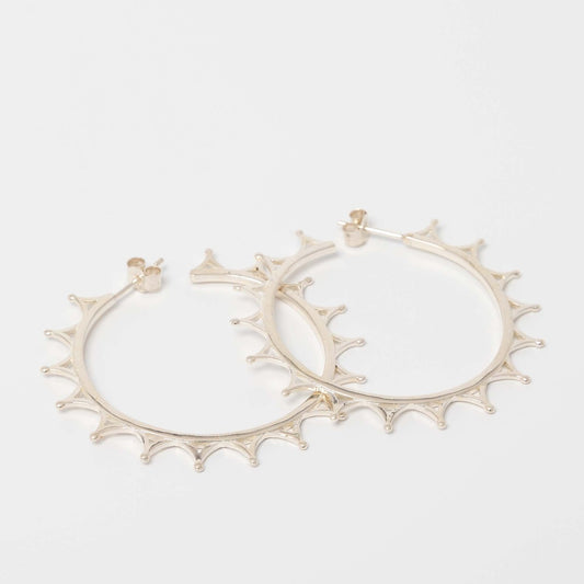 Sterling silver crown hoop earrings, inspired by Queen Elizabeth II’s tiara, handcrafted from recycled silver. Elegant and timeless, part of the Jubilee Crown Collection.