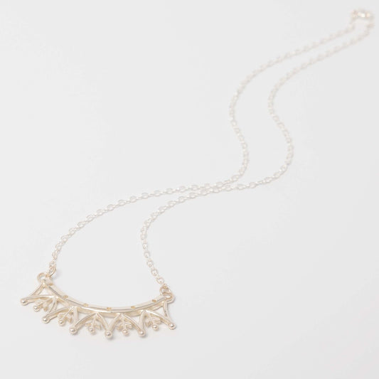 Flatlay of the Jubilee Crown Necklace displayed on a neutral background, showcasing the elegant sterling silver chain and royal motif.