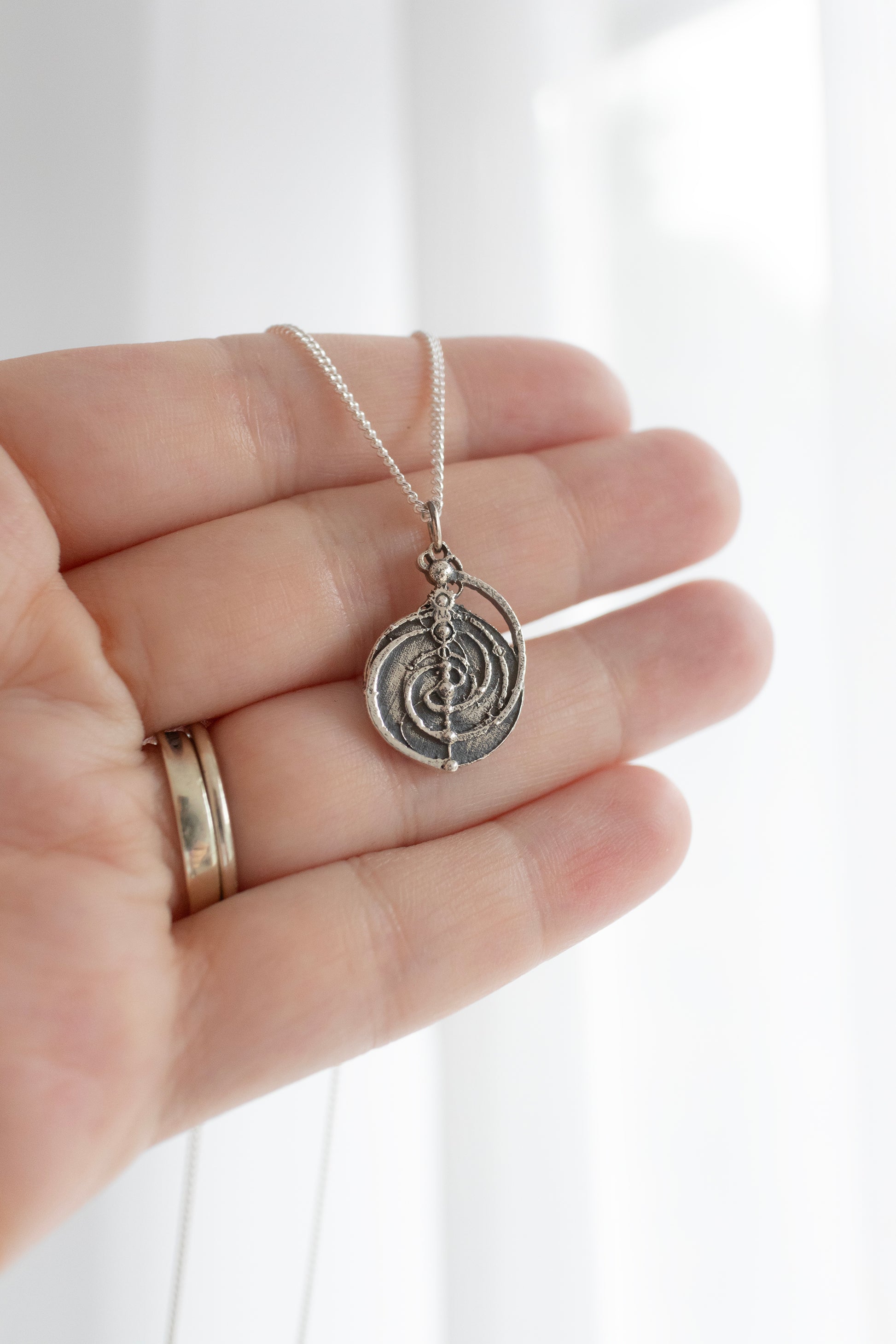 Handcrafted sterling silver Mystic Spiral Constellation Mandala Necklace, a smaller version of the Master Time Spiral from The Dark Crystal. A meaningful and symbolic gift for film enthusiasts