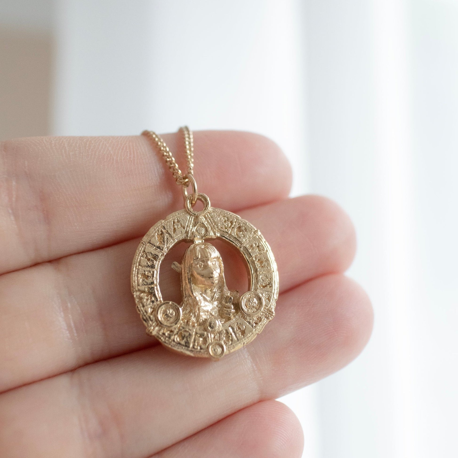 Handcrafted 18ct gold vermeil Aughra's Triangle Necklace, featuring the mystical triangle design and Eye of the superimposed suns. Inspired by Jim Henson’s The Dark Crystal, perfect for gifting.