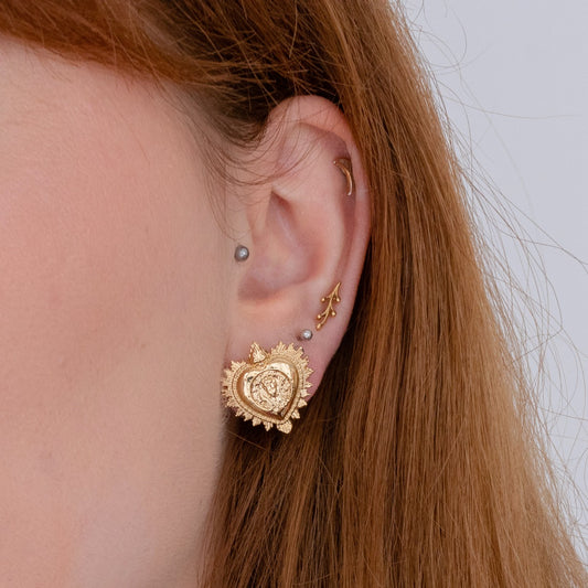 Model wearing the Viva La Vida Heart Earrings, showcasing their bold, symbolic style and gold vermeil finish.