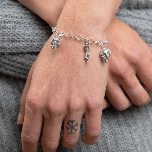 Frida Kahlo Skull Charm Bracelet in sterling silver featuring the Aztec Skull, 'F' Charm, and Pointing Hand Charm from the Love & Pain Collection.