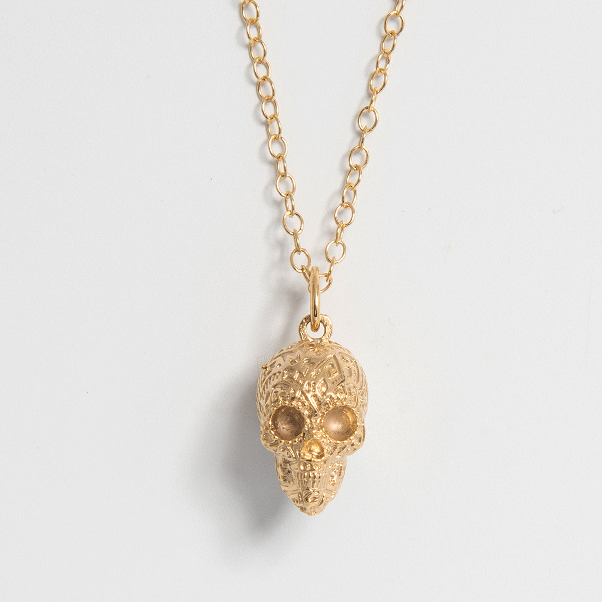 Aztec Skull Charm Necklace inspired by Frida Kahlo, blending tradition and modern style. Available in sterling silver or 18ct gold vermeil, handmade in the UK.