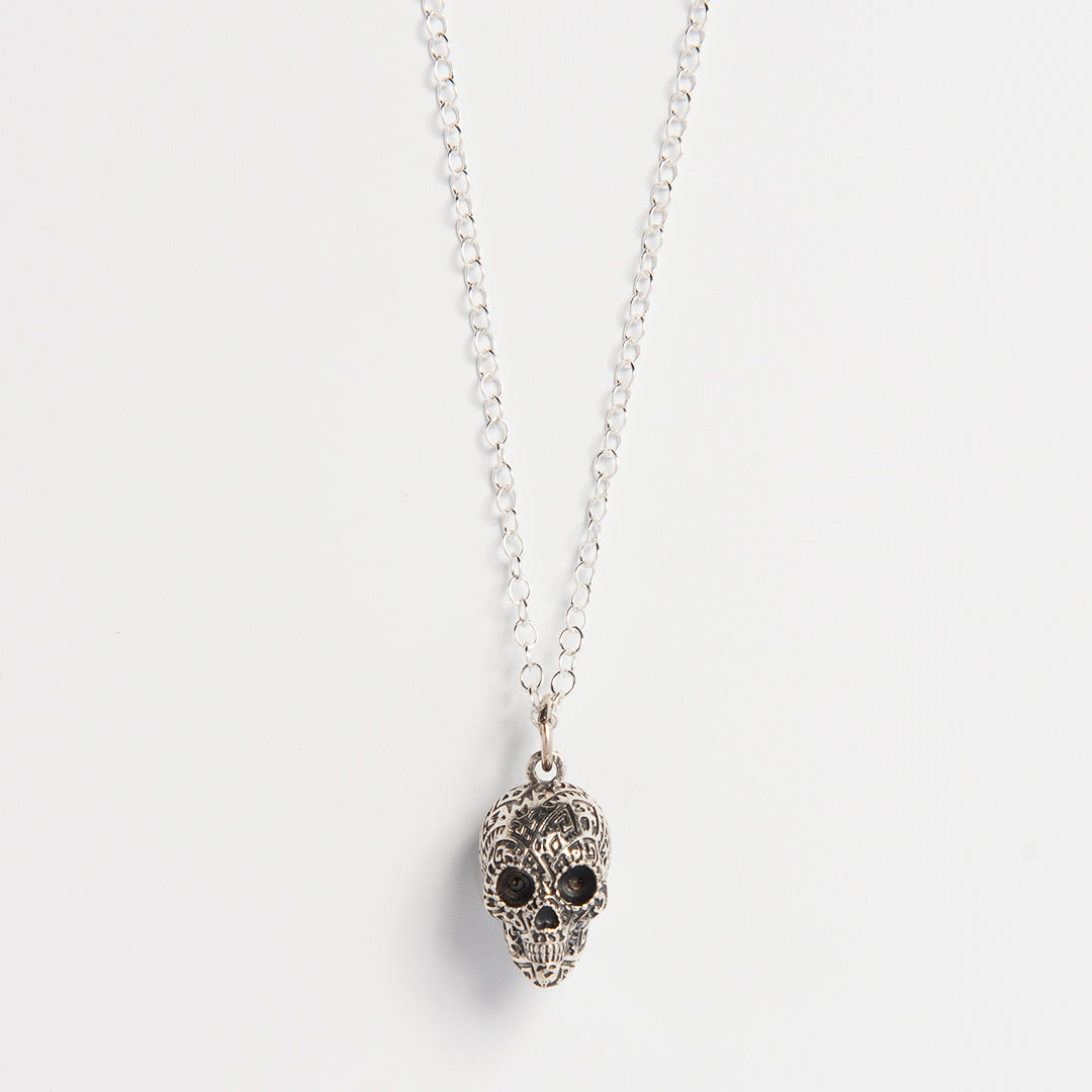 Front-facing view of the Frida Kahlo Aztec Skull Necklace in sterling silver, showcasing the intricate skull design inspired by traditional Mexican motifs.
