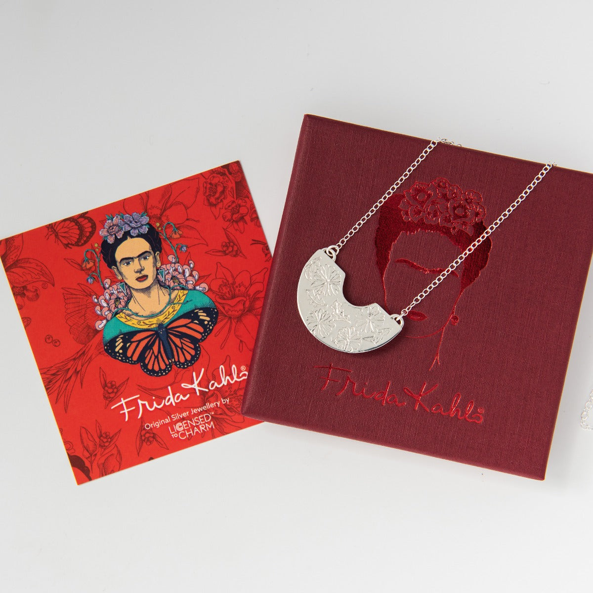 Close-up view of semi-circle pendant on Creole Necklace showing detailed marigold engraving in sterling silver.