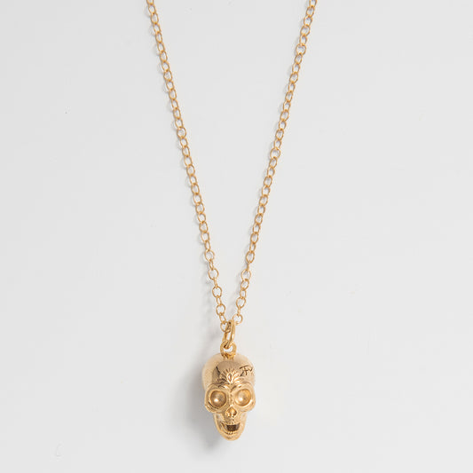 Front-facing view of the Frida Kahlo Calavera Skull Necklace in 18ct gold vermeil, featuring a detailed skull charm on a delicate trace chain.