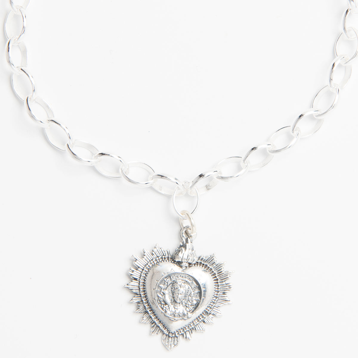 Close-up of sterling silver bracelet with Frida Kahlo-inspired charms.