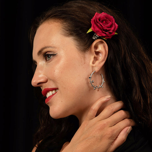 Model wearing sterling silver Thorn Hoops with dark blazer, emphasising their gothic chic appeal.