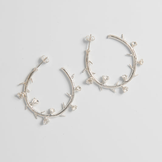 Front view of the Frida Kahlo Thorn Hoop Earrings in sterling silver, highlighting the sculptural thorn-inspired design.
