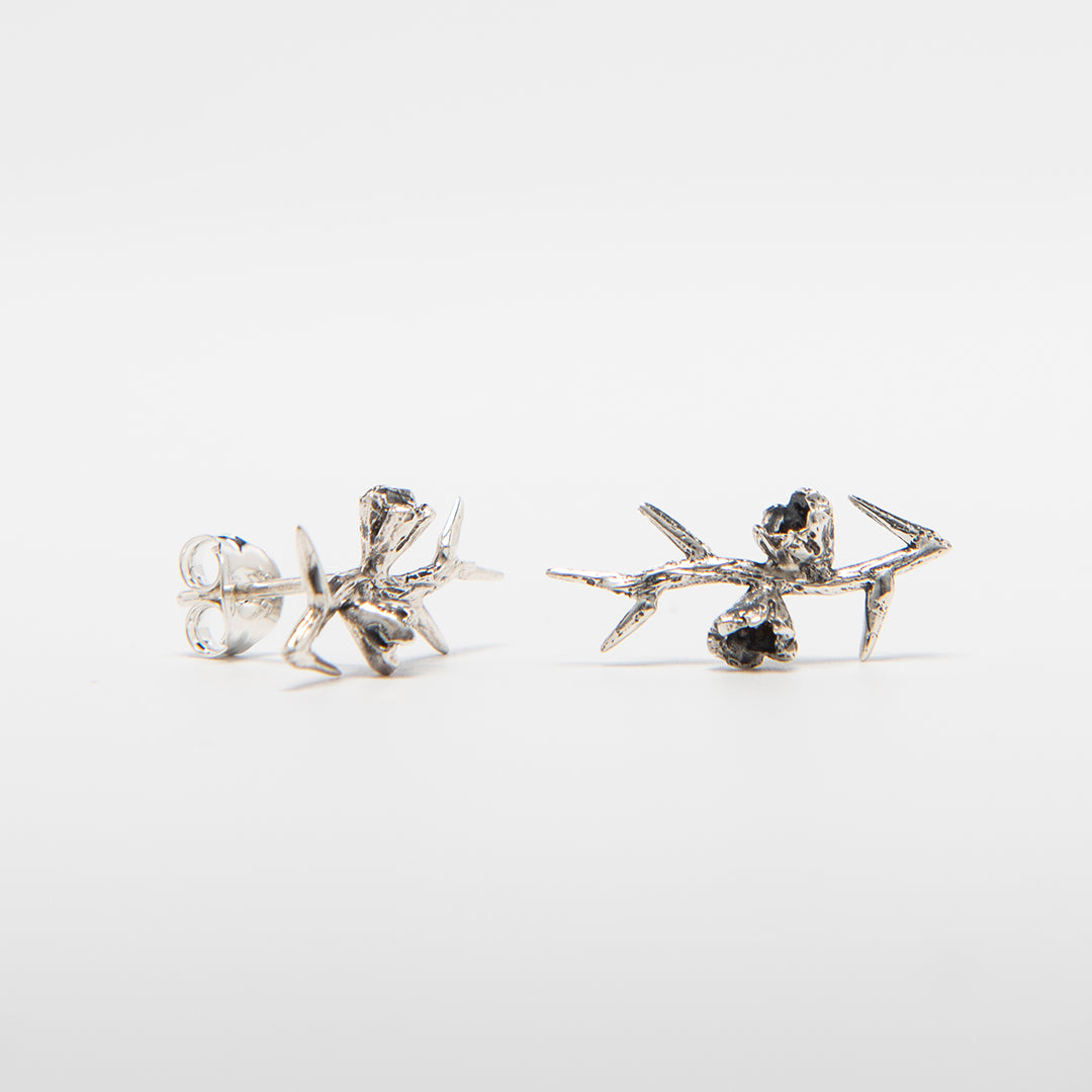 Front-facing view of the Frida Kahlo Thorn Stud Earrings in sterling silver, featuring a sculptural thorn design inspired by Frida’s self-portrait.
