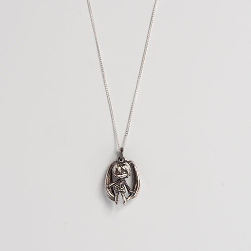 Close-up of the oxidized sterling silver Hatsune Miku pendant, highlighting the enhanced linework and 3D sculpting.
