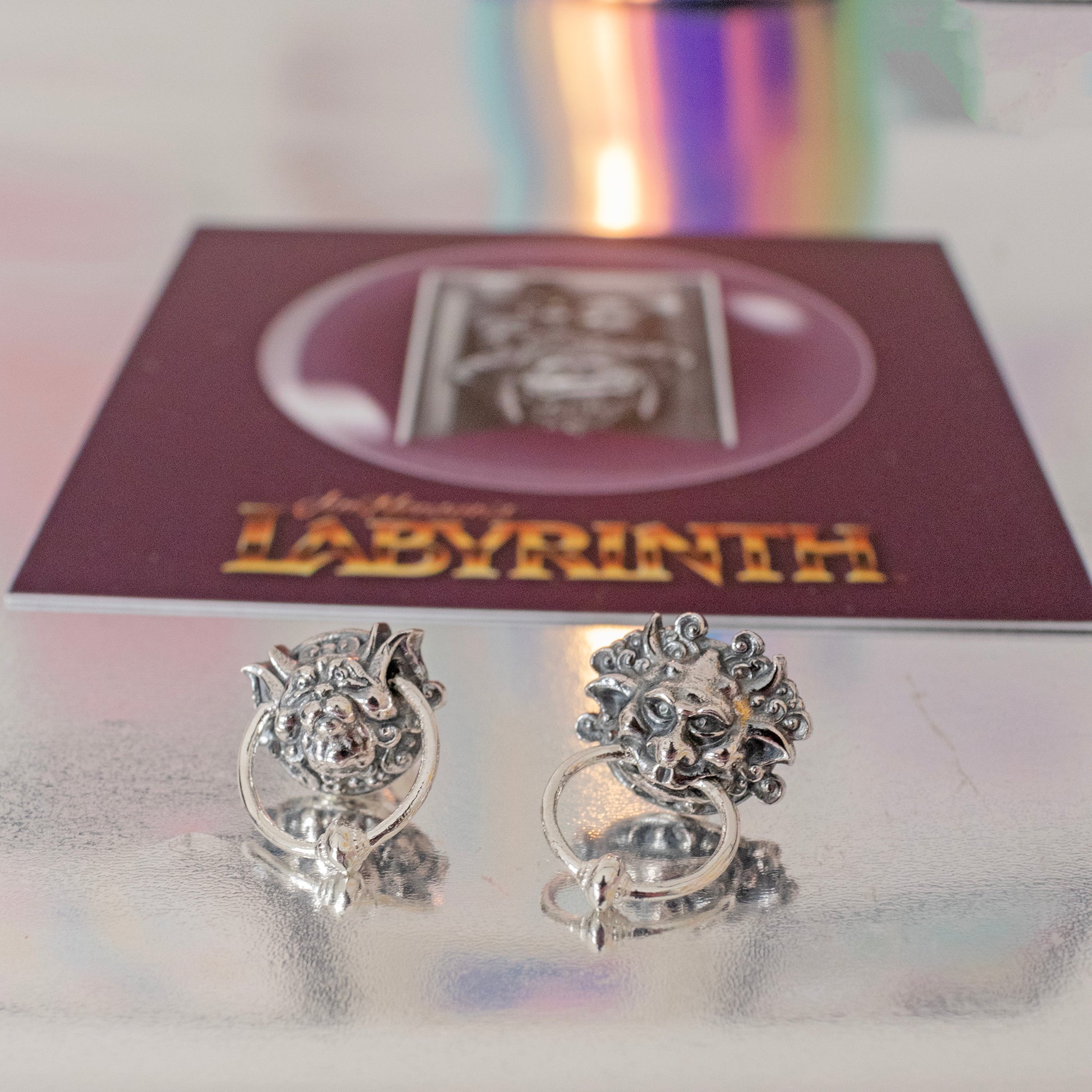 Labyrinth Door Knocker Earrings displayed in branded gift box surrounded by Labyrinth-themed props – perfect fantasy gift for film lovers.