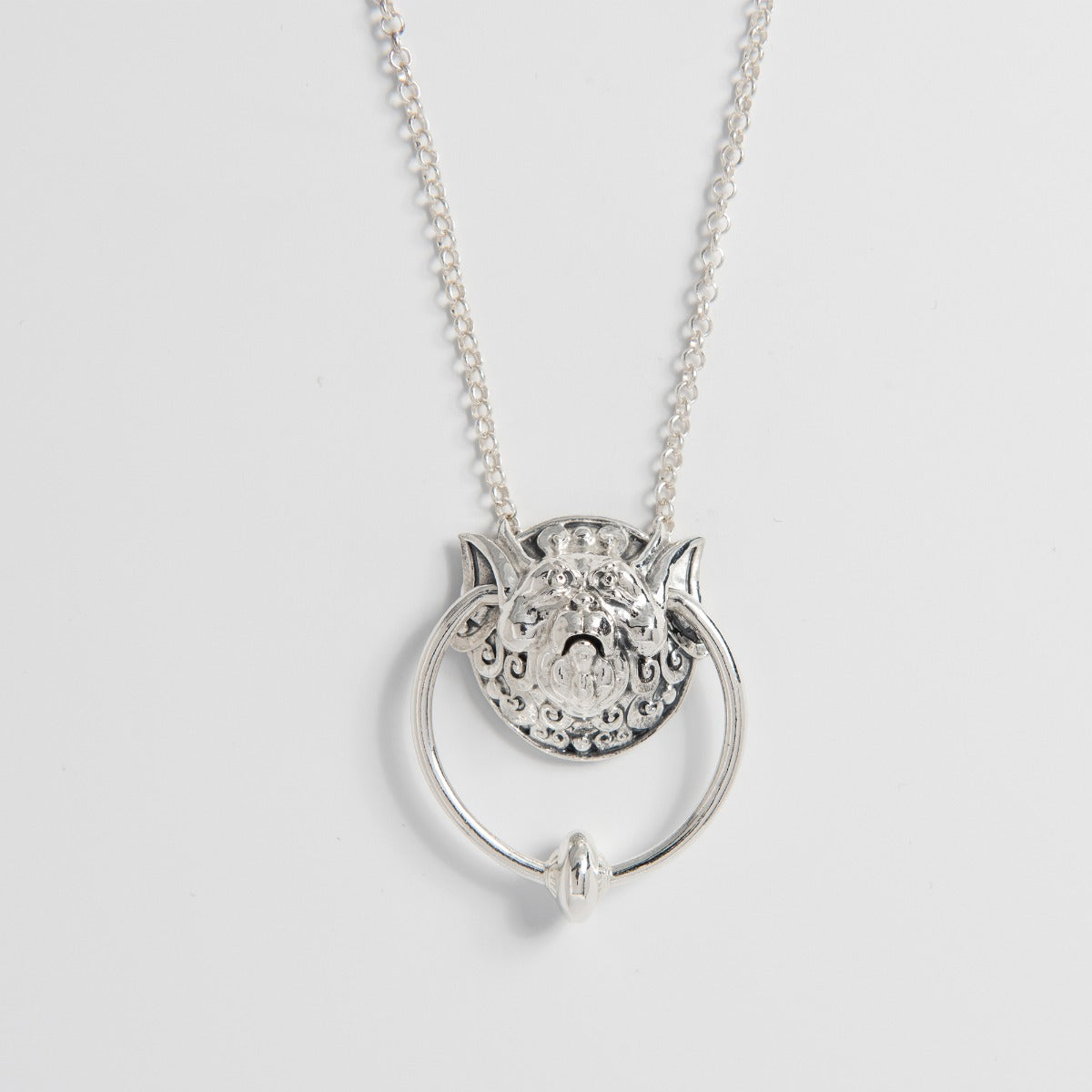Sterling Silver Right Door Knocker Necklace from Jim Henson’s Labyrinth. Features the iconic, eccentric right door knocker with a movable ring through his ears, intricately handcrafted from sustainable sterling silver. A whimsical tribute for fans of the classic film