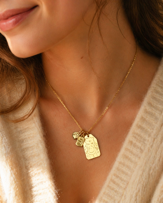 Licensed To Charm gold Paddington tag necklace worn on model.