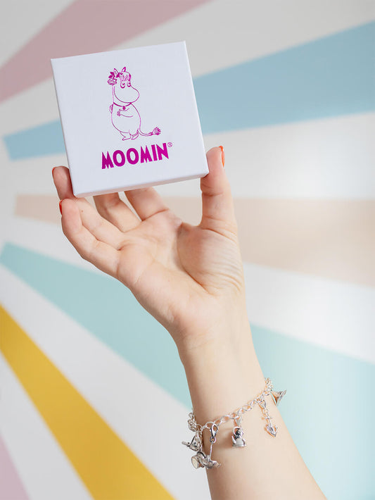 Close-up of model's arm wearing complete Moomin charm bracelet with multiple sterling silver charms