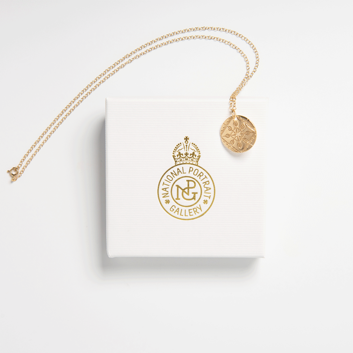 Close-up of the gold vermeil Solid Lace Necklace pendant, highlighting the intricate lace detailing and polished disc finish.