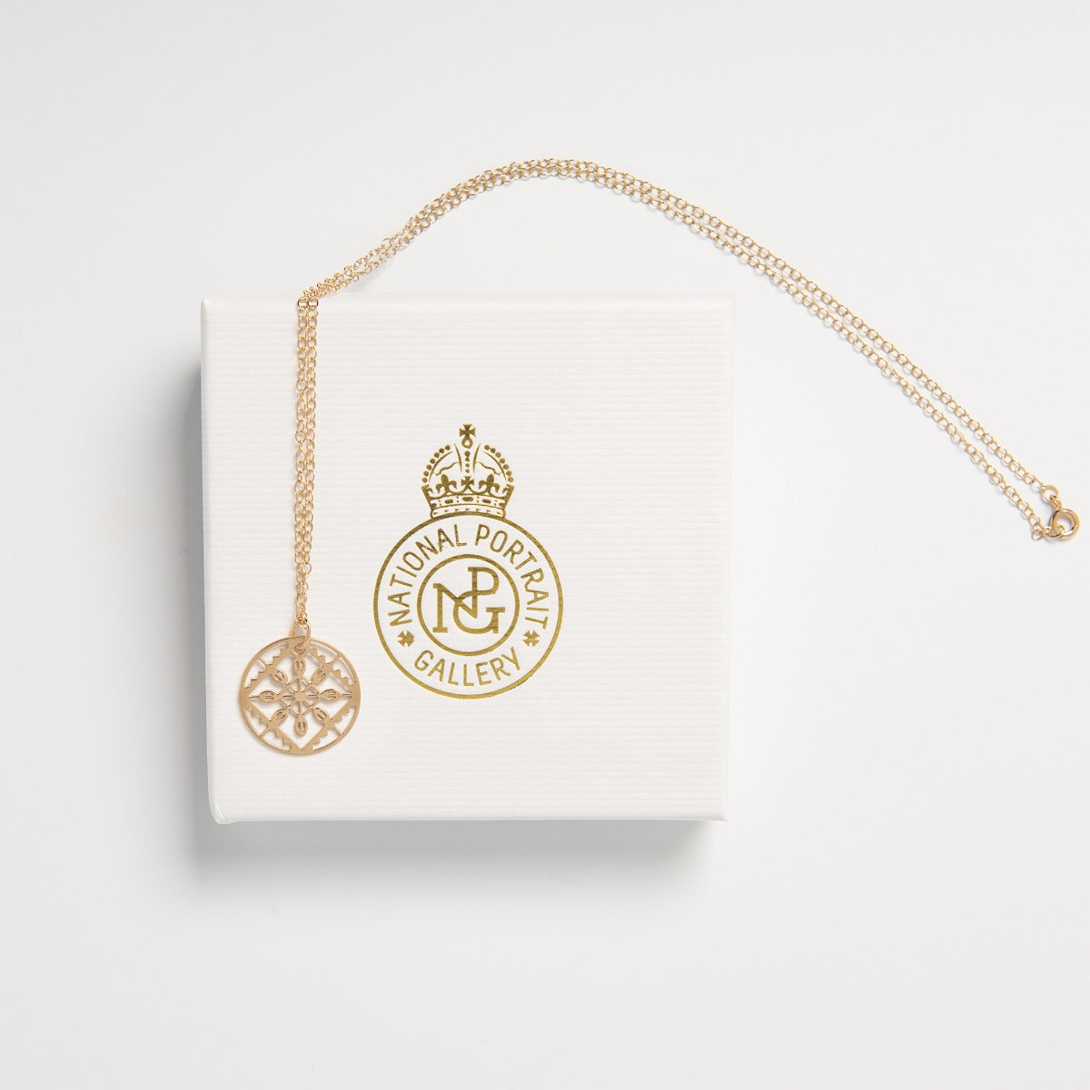 Close-up of the gold vermeil Lace Necklace pendant, highlighting the intricate lace motif and polished finish with packing