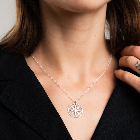 Close-up of the sterling silver Lace Necklace pendant highlighting the delicate lace motif and polished handcrafted finish.