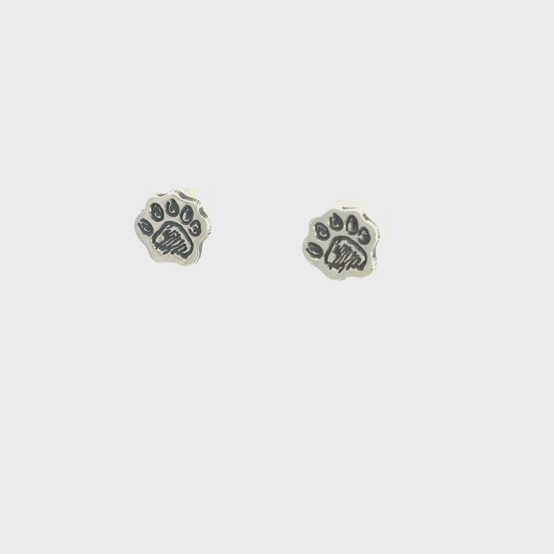 Rotating view of Paddington™ Paw Stud Earrings in sterling silver, officially licensed handmade jewellery inspired by Michael Bond.